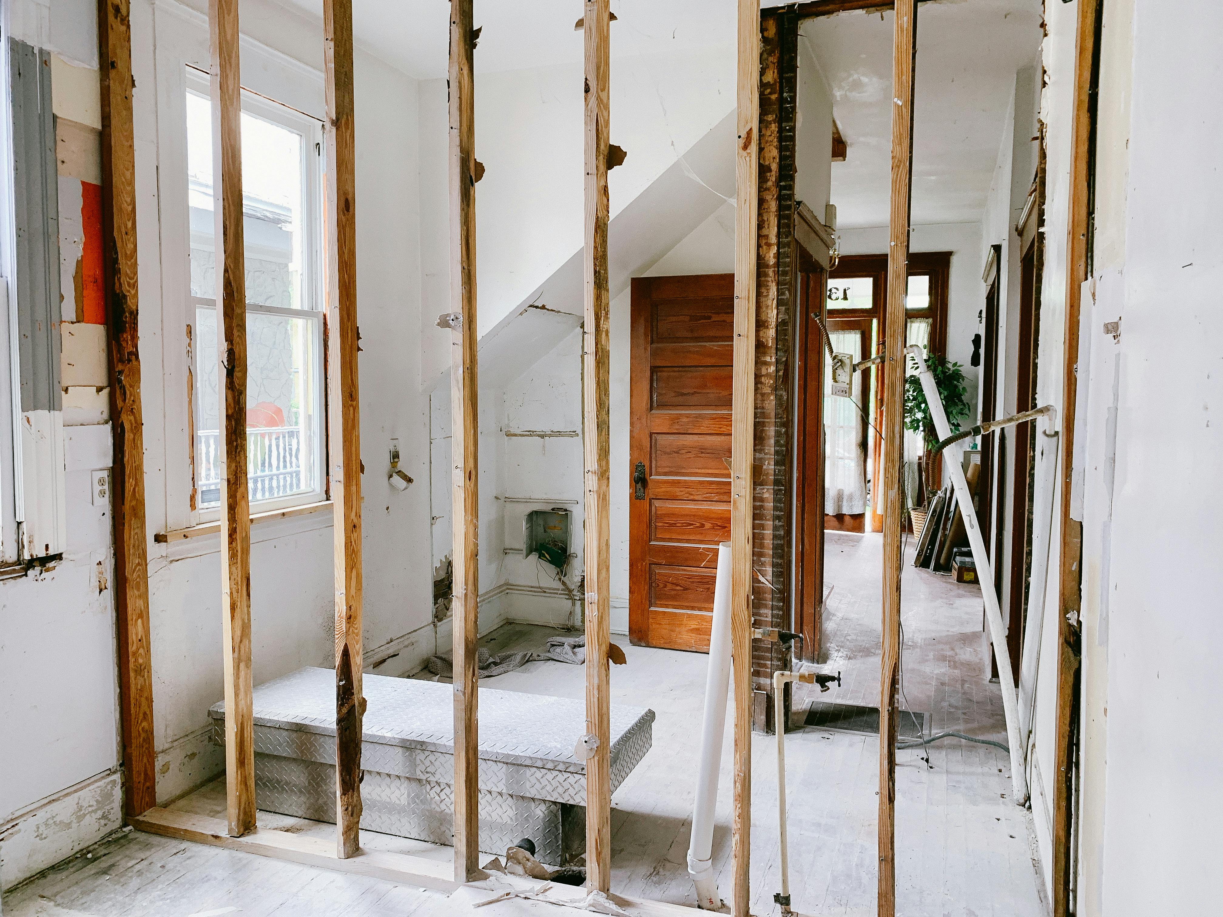 An interior renovation; wood beams in front of an empty house