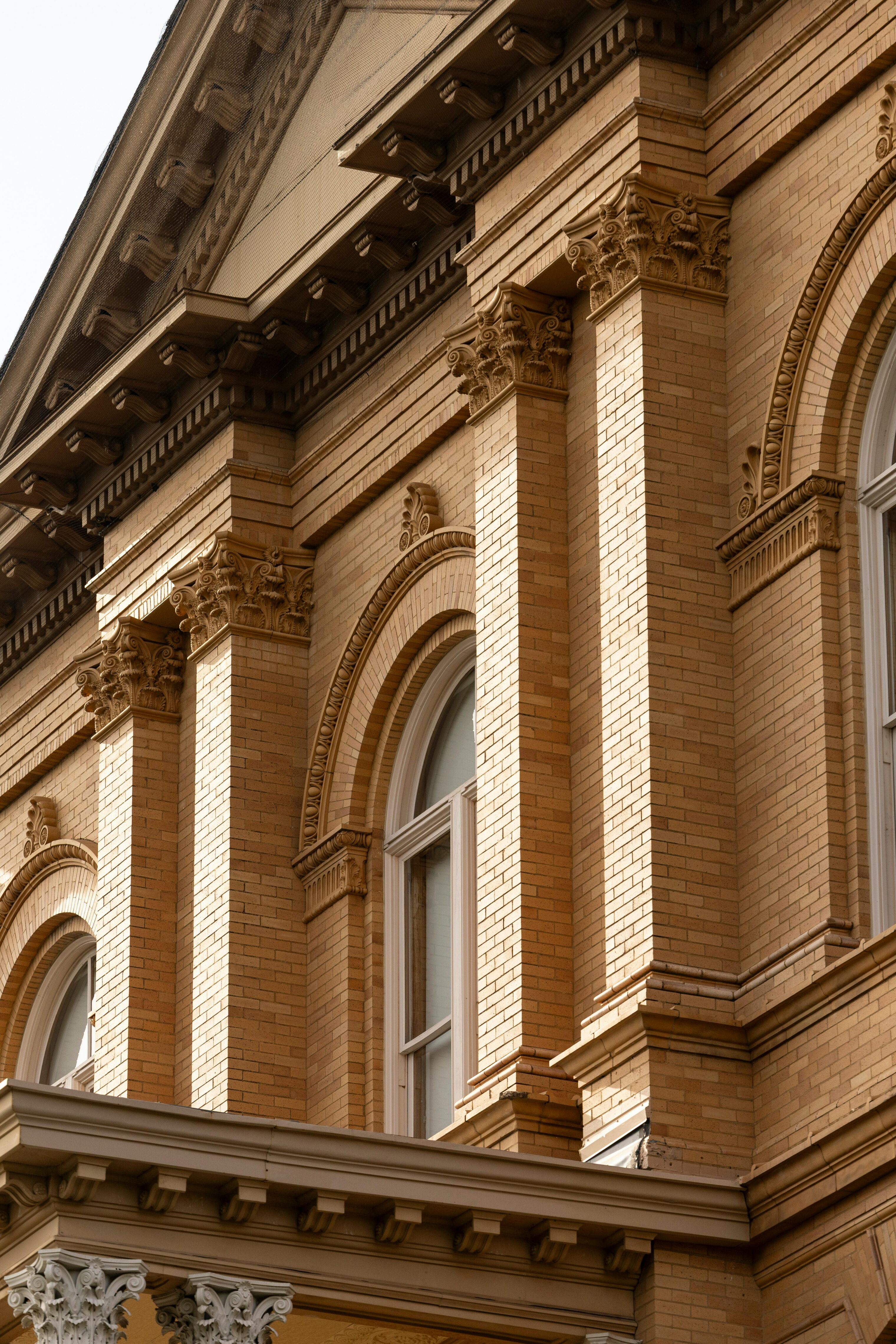 Zoomed in facade of a historic brick building.