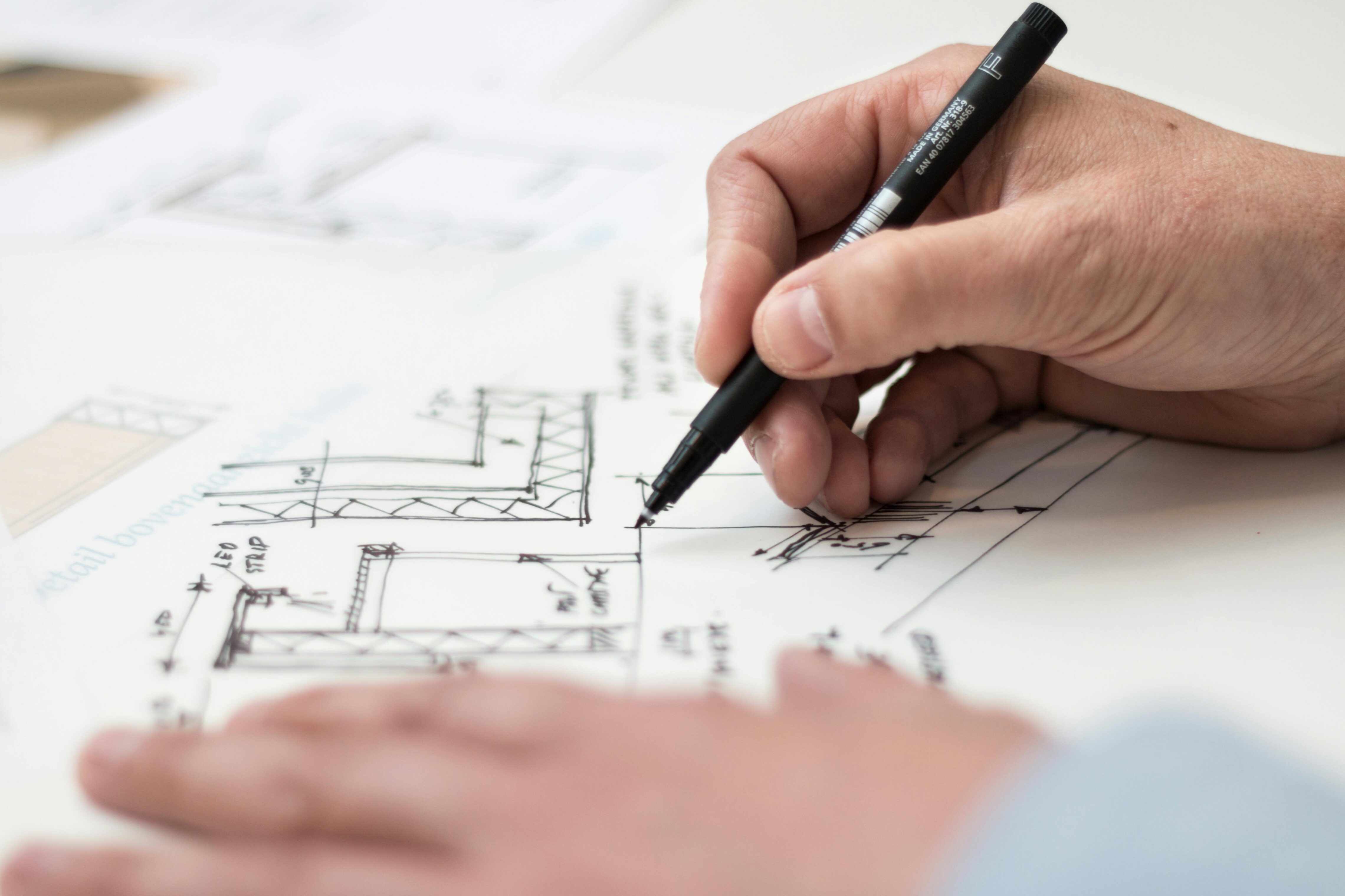 Person sketching floor plans