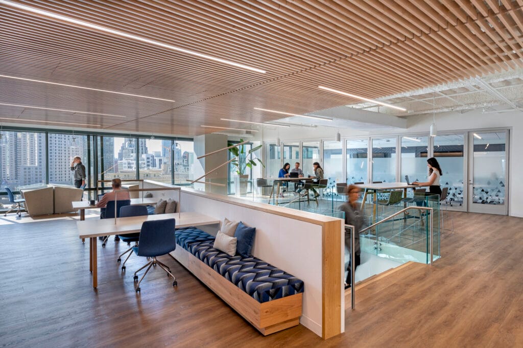 Interior of a building with tables, chairs, and a staircase