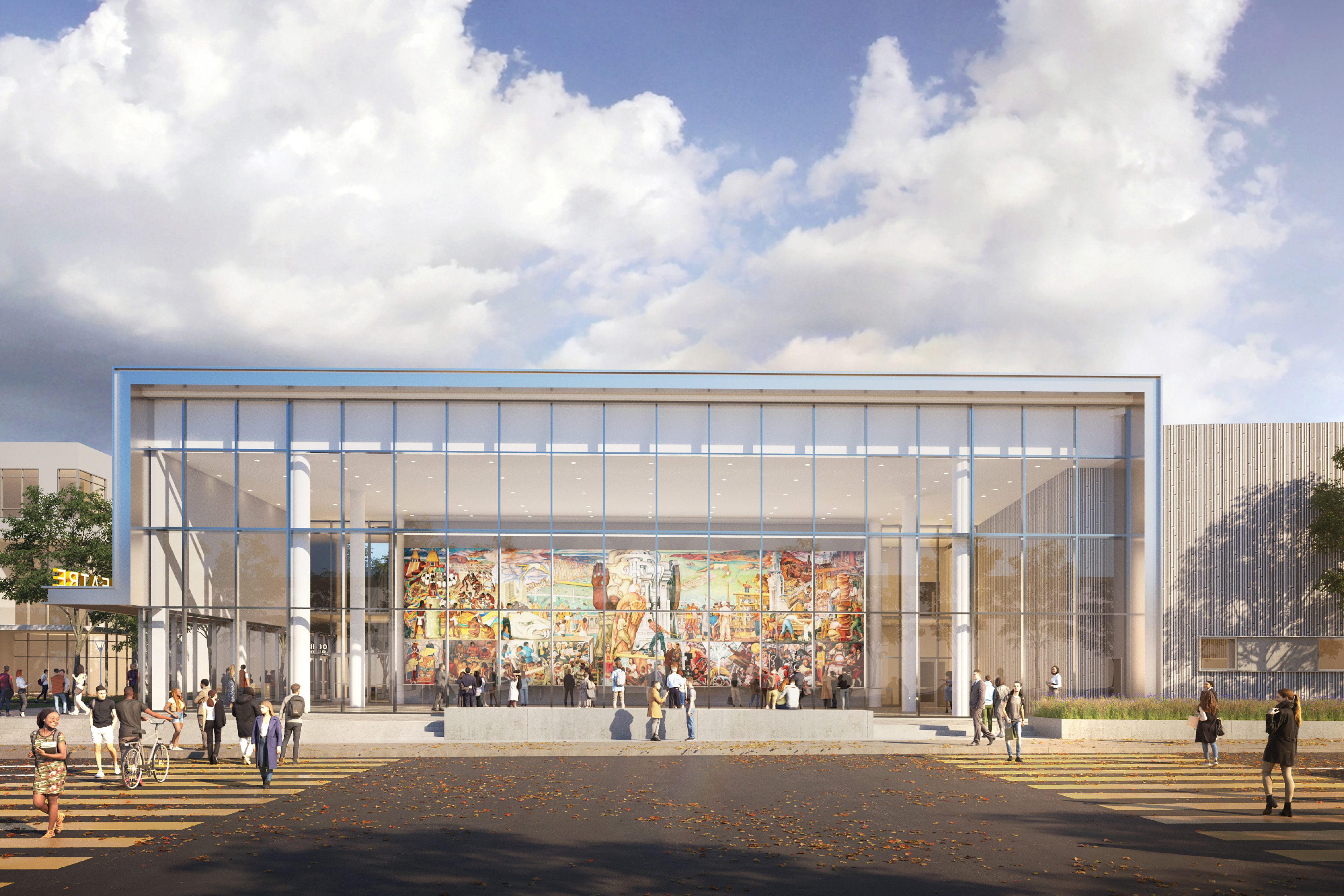 Exterior view of the Diego Rivera Theater with a transparent glass façade revealing the Diego Rivera mural and people gathering outside.