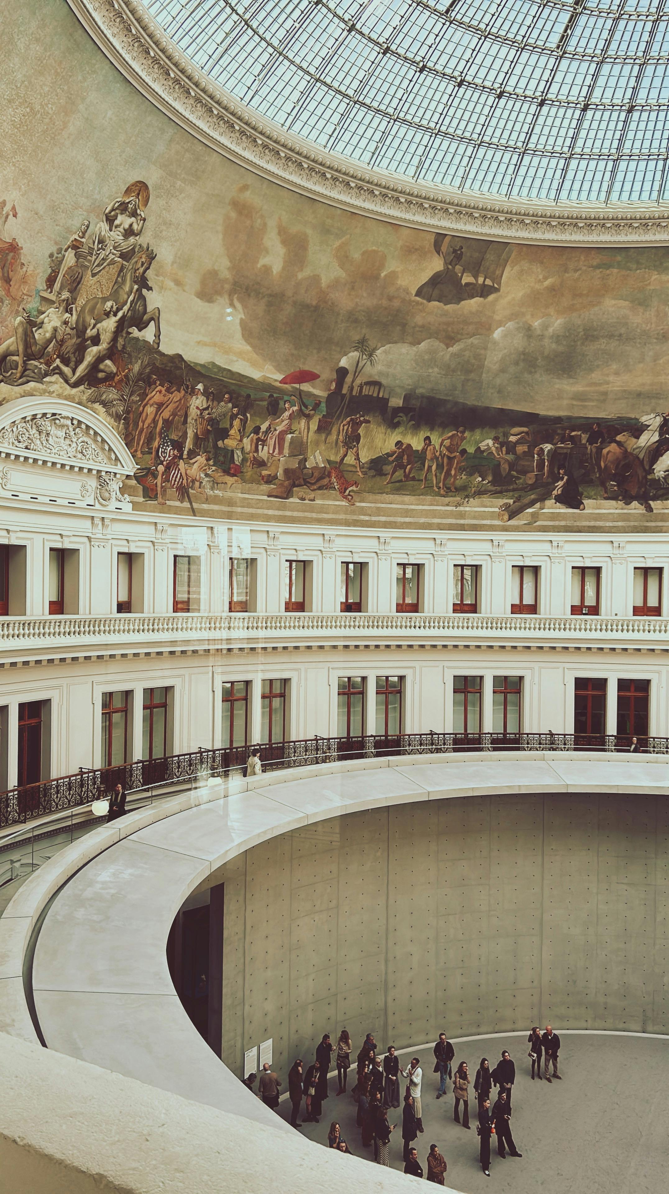 Ornate building in France with mural and round basin