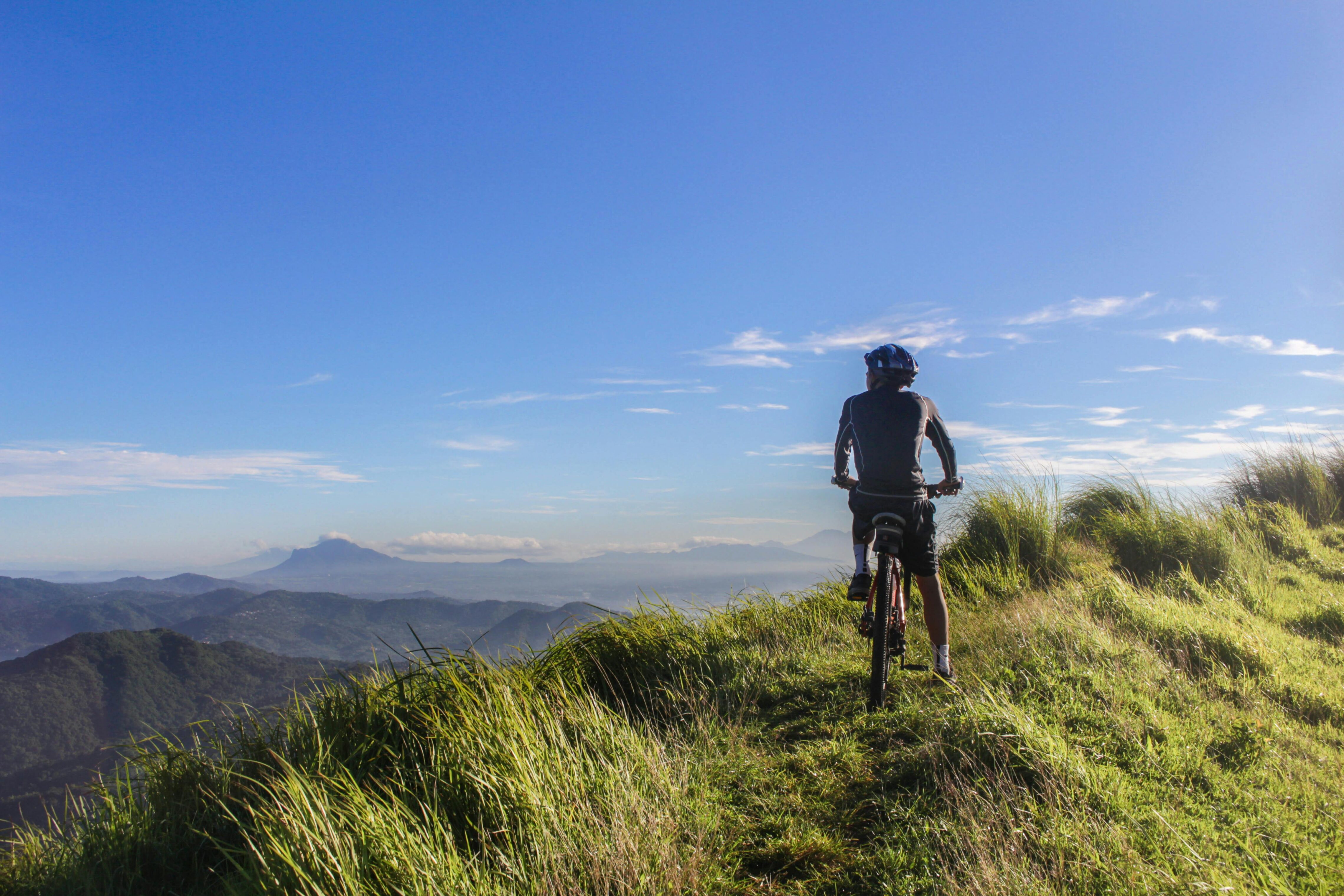 Biker on a grassy hill