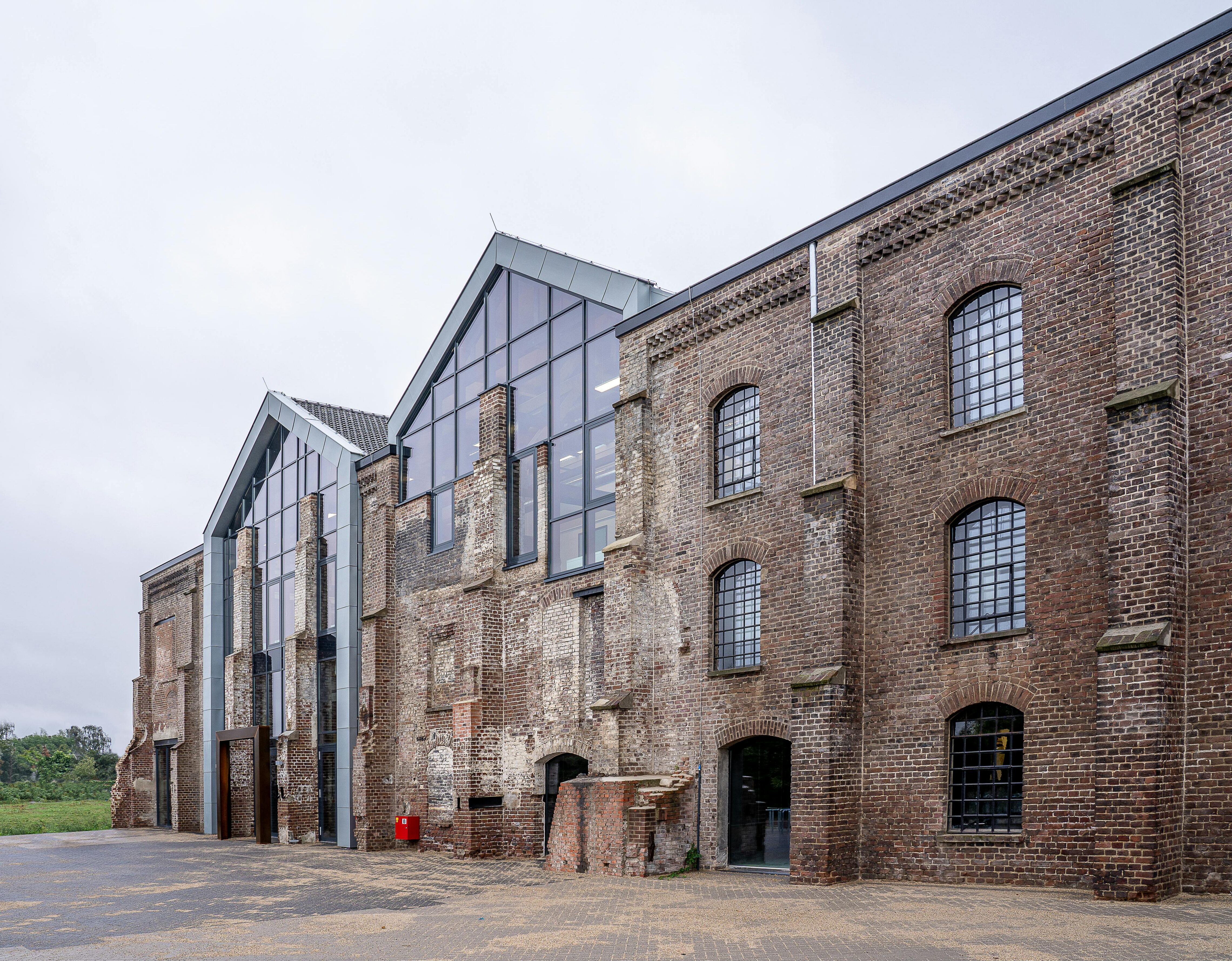 Old brick building with new glass part of facade