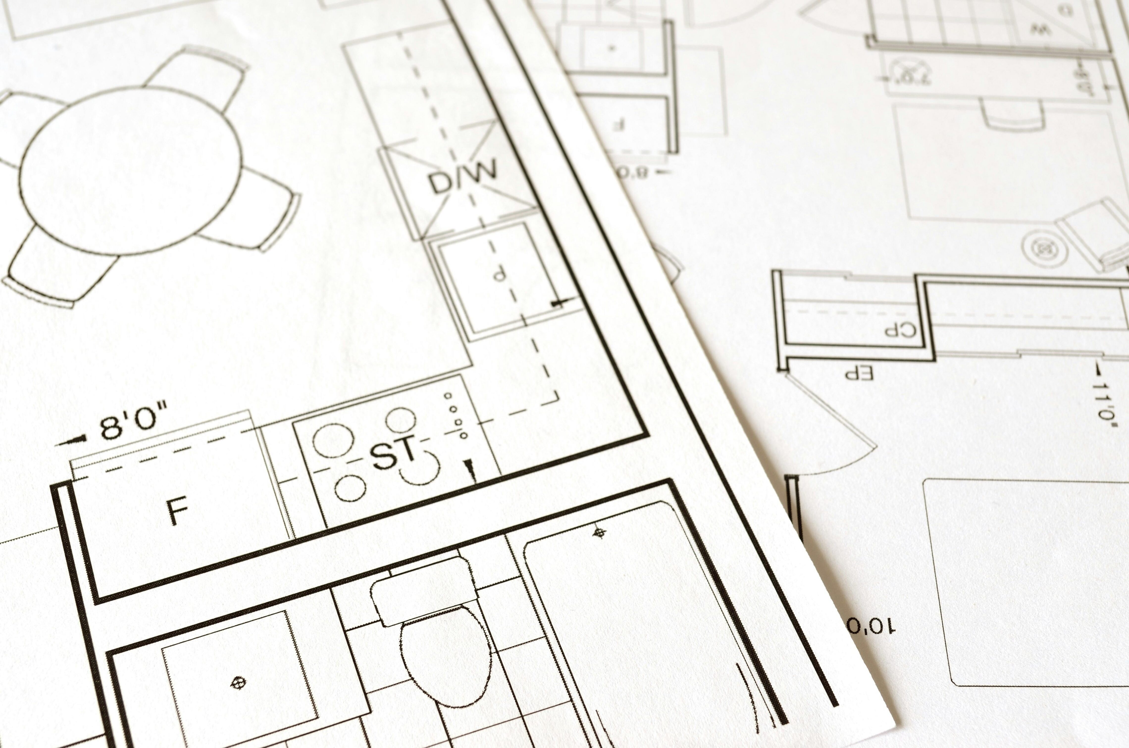 Close-up of black and white floor plans on paper