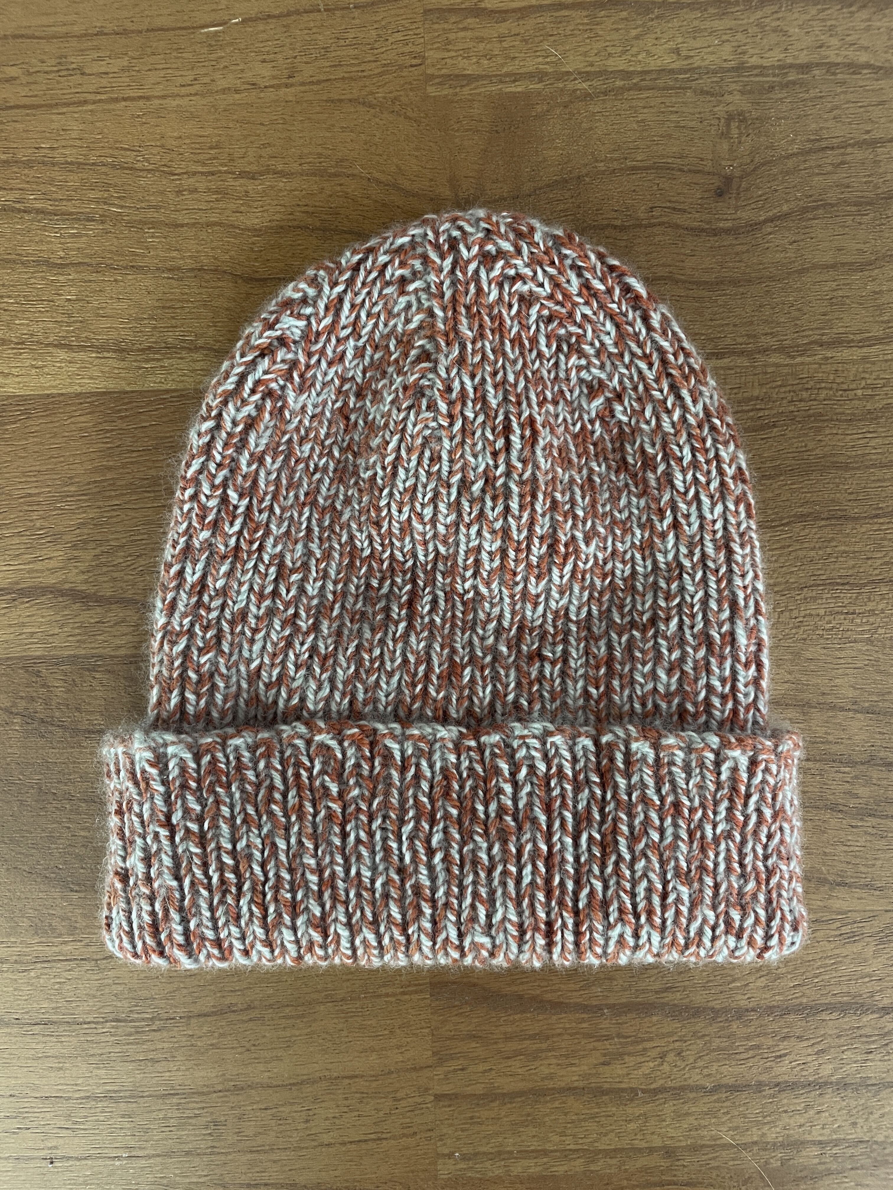 A red and white hand-knitted beanie