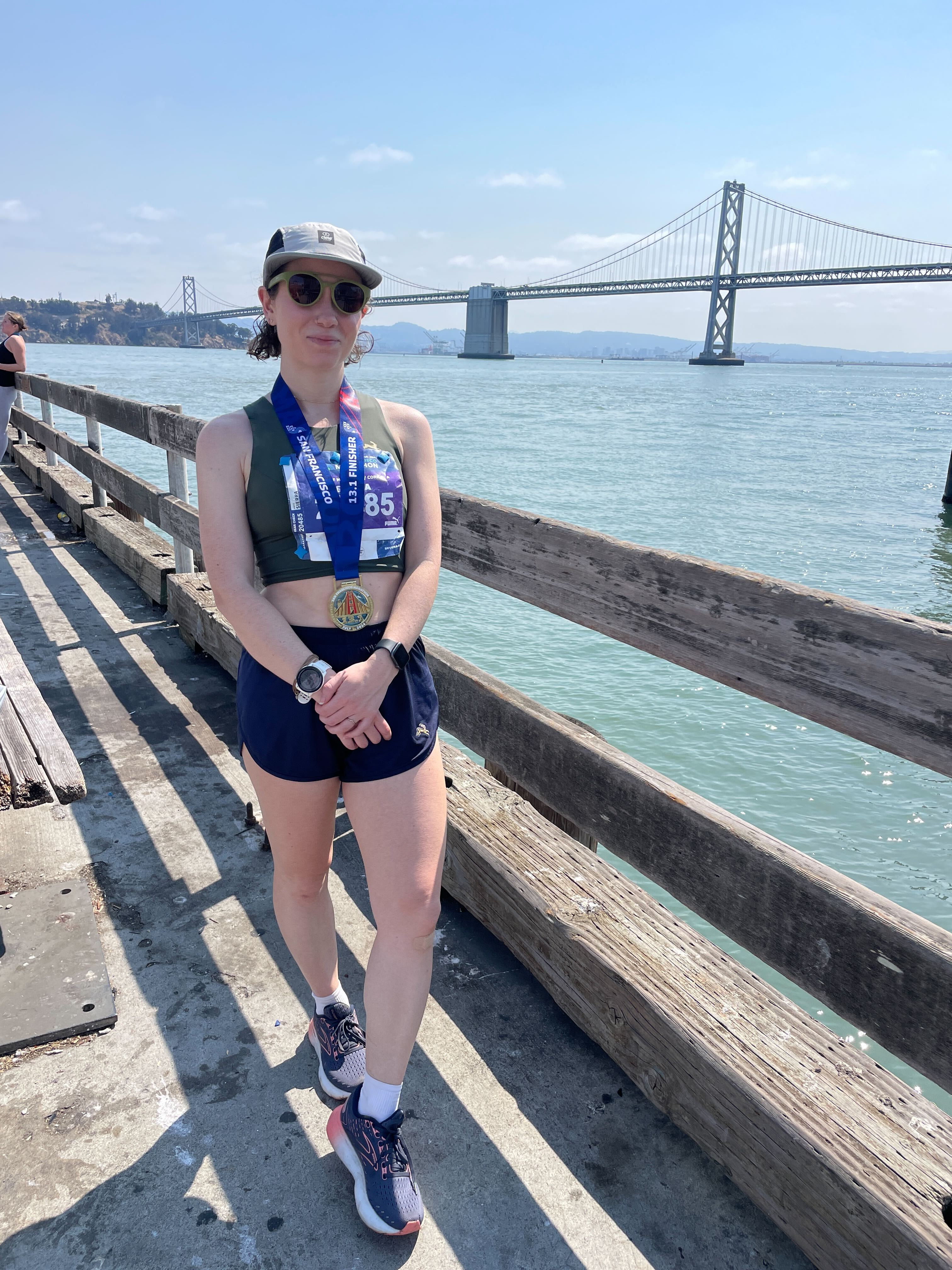 Woman during a marathon in front of a bridge