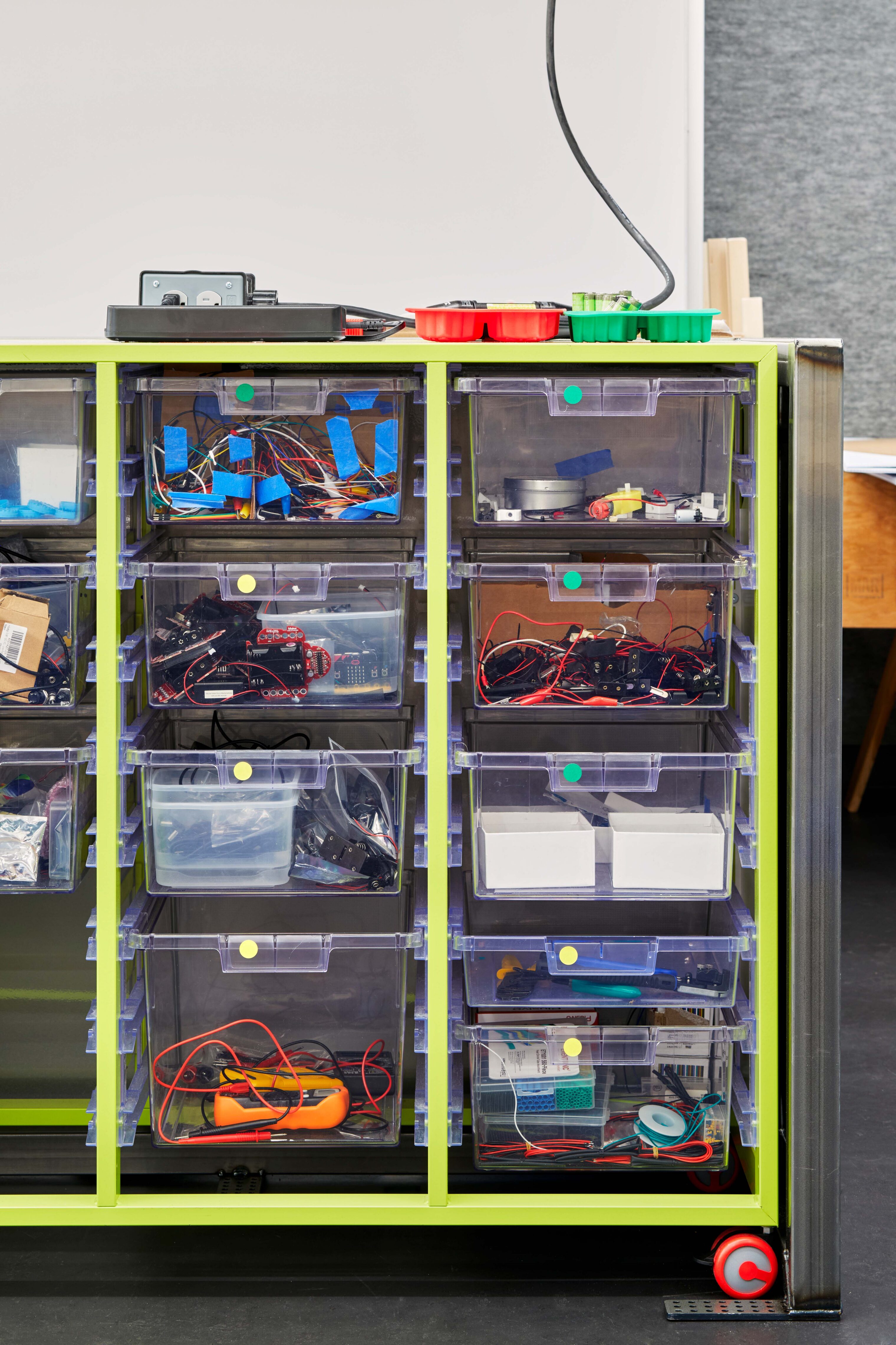 Transparent storage bins hold electronics components and maker supplies in a mobile storage unit used throughout the Engineering Studio.