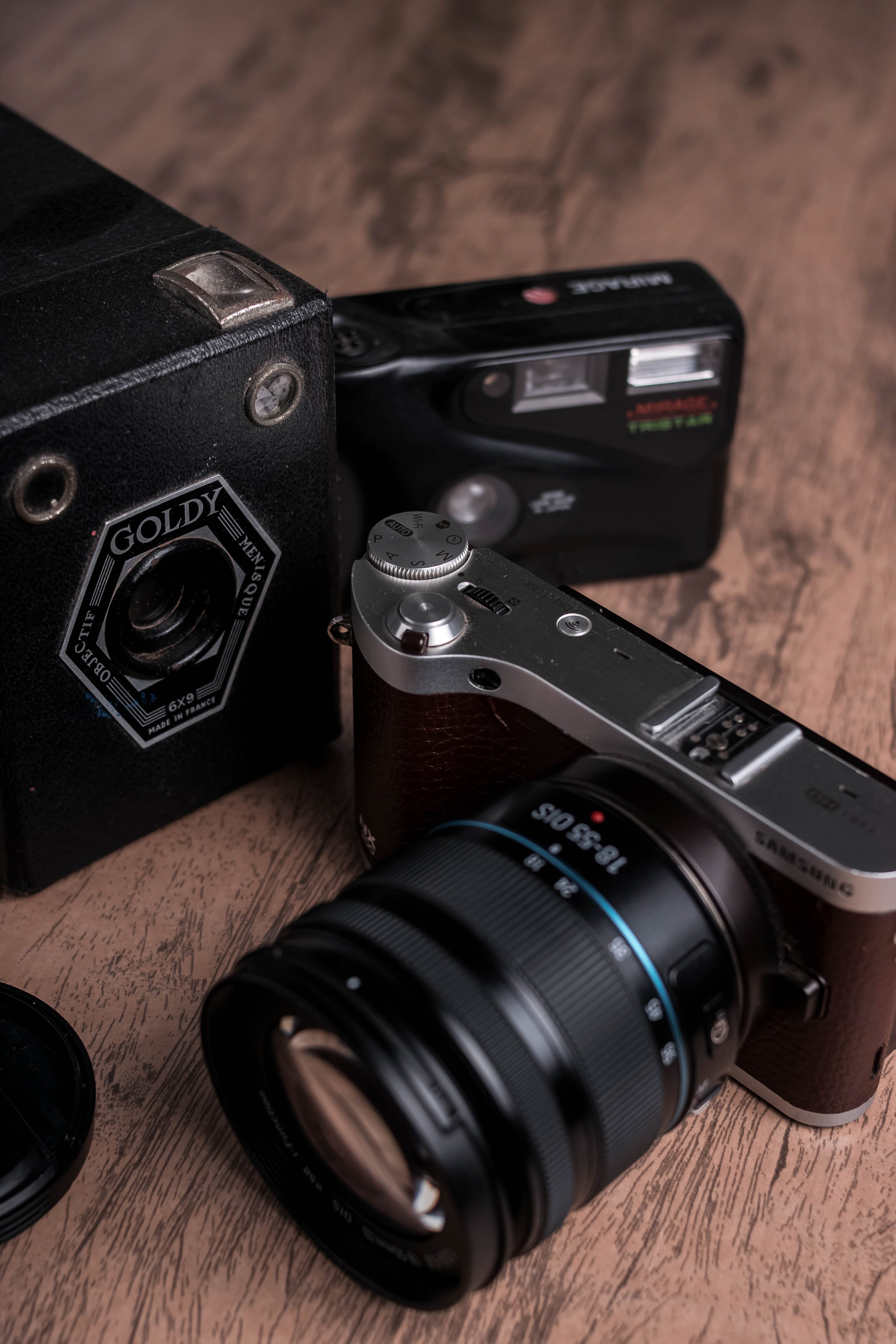 Two small handheld digital cameras on a table.