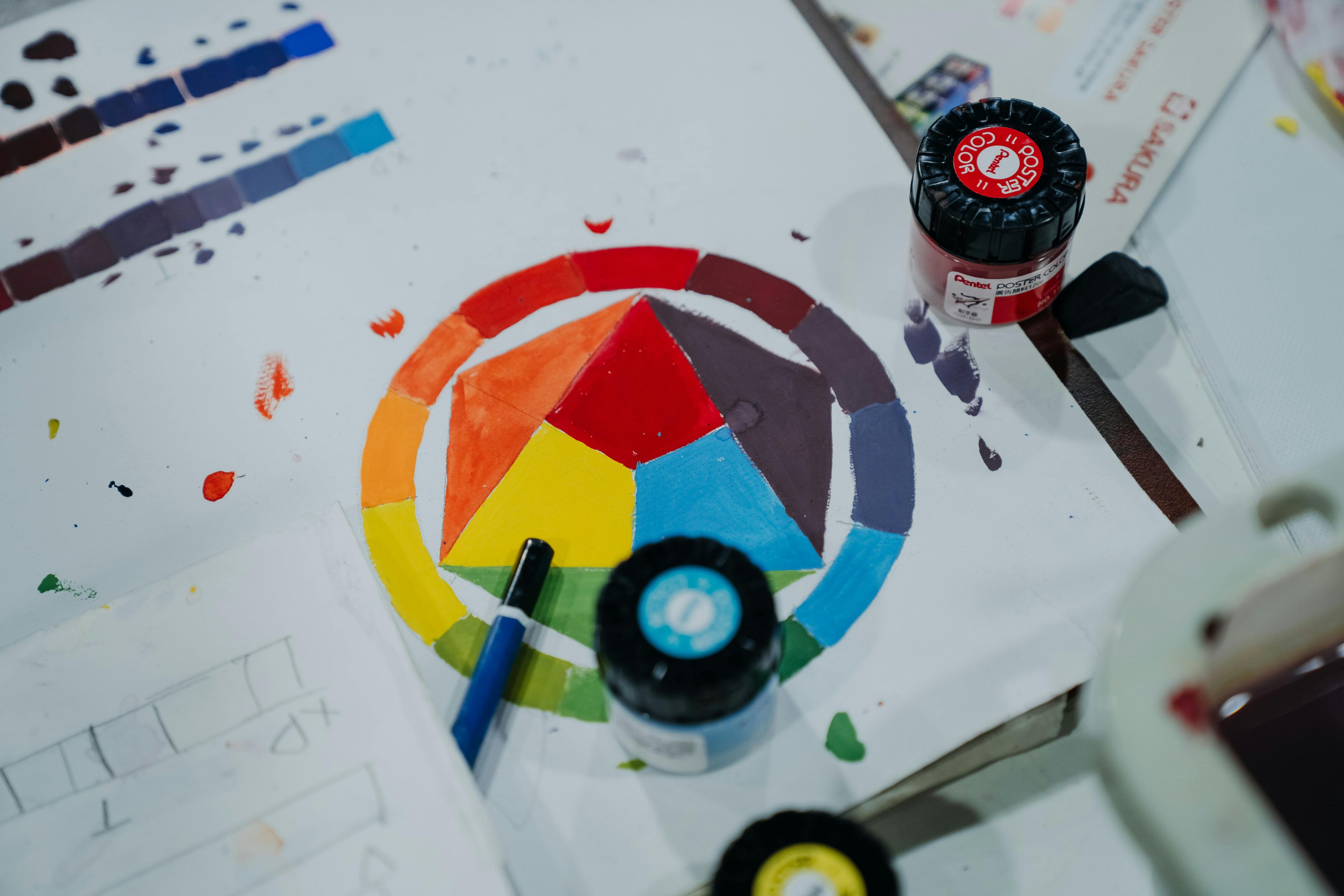 Paint tubs surrounding a painted hexagonal color chart.