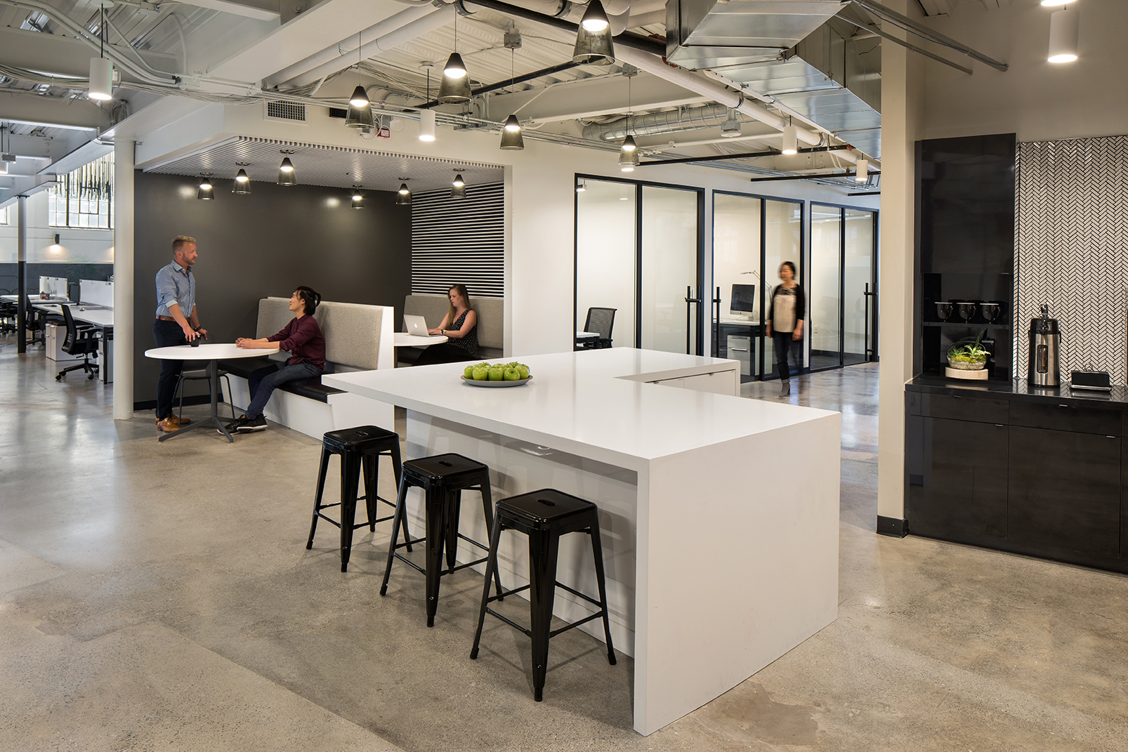 A restrained black-and-white palette keeps the focus on the building's original deep red brick and grey concrete, clearly distinguishing historic materials from contemporary interventions.